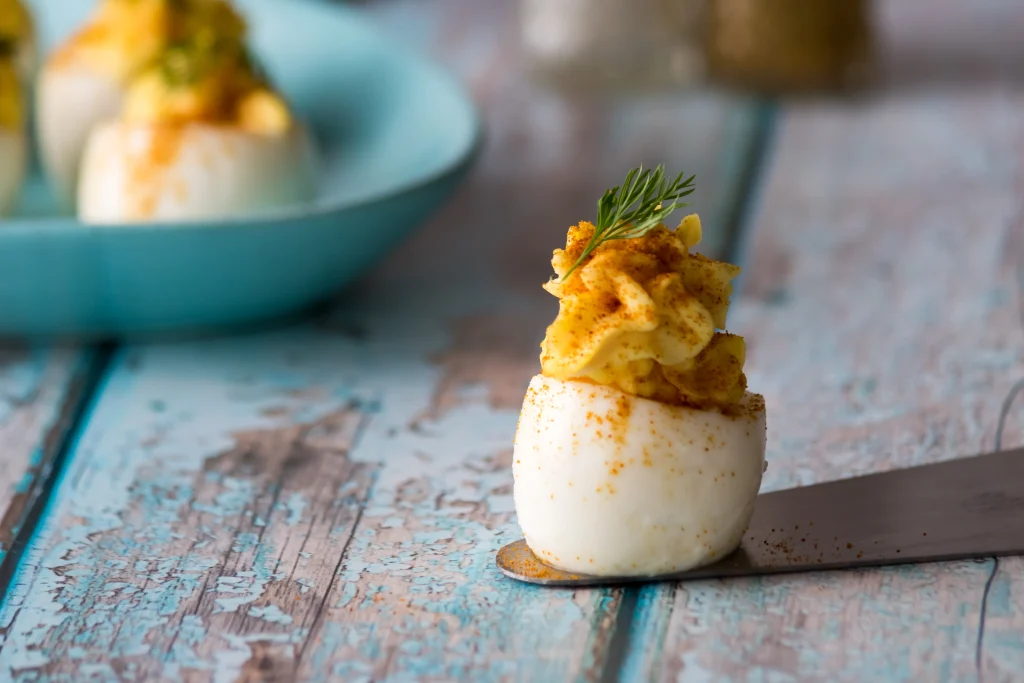 Easy classic deviled eggs topped with paprika, an affordable family-friendly appetizer under $5