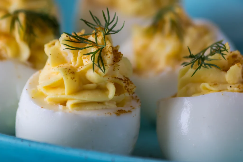 Easy classic deviled eggs topped with paprika, an affordable family-friendly appetizer under $5.