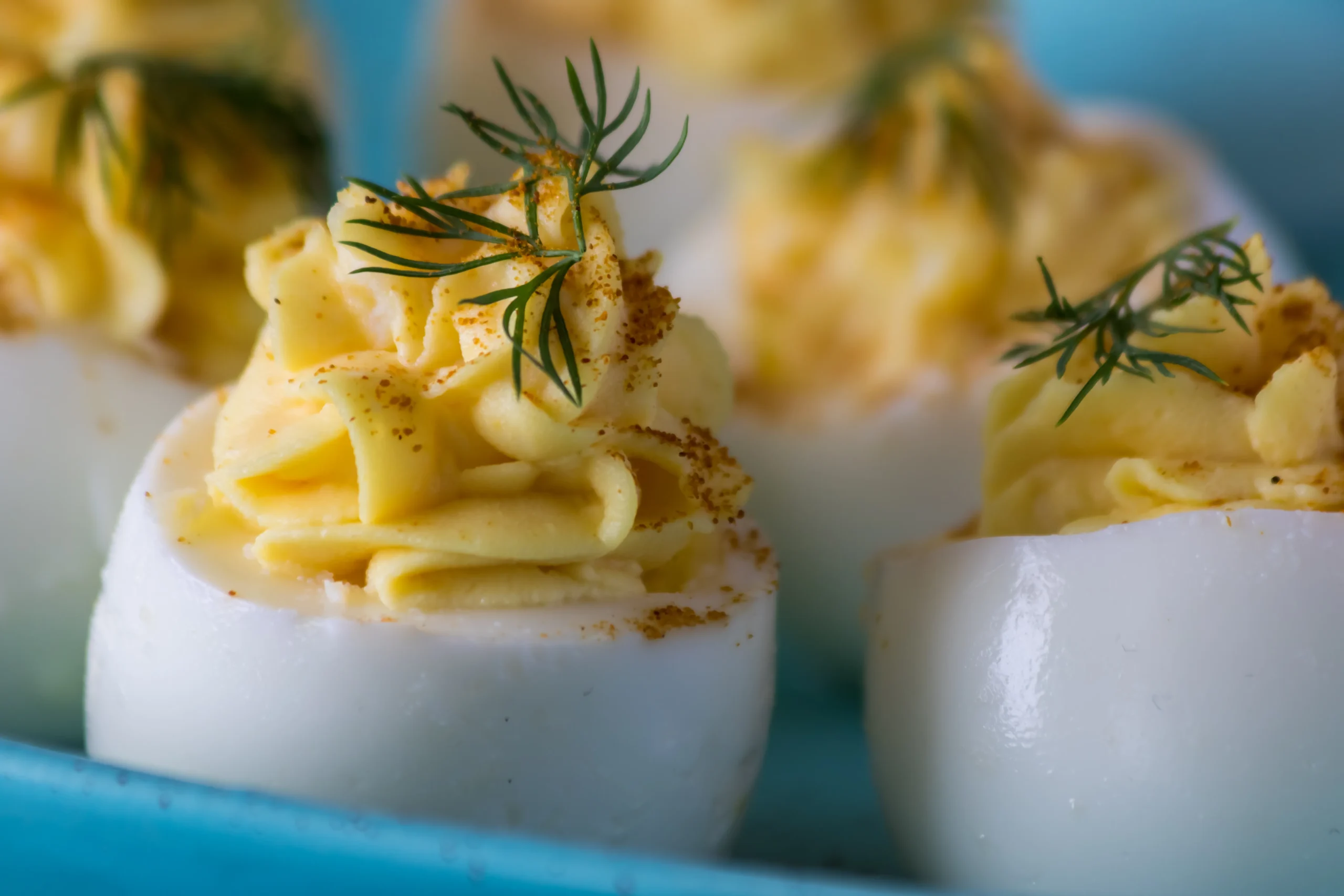 Easy classic deviled eggs topped with paprika, an affordable family-friendly appetizer under $5.