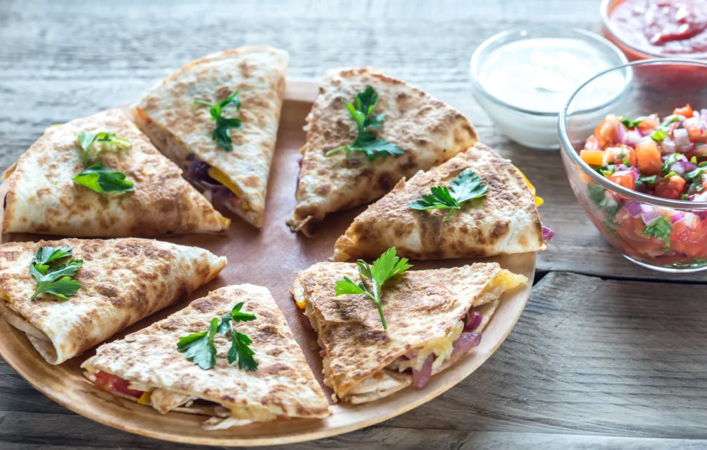 heesy black bean quesadilla triangles with melted cheese in crispy golden tortillas